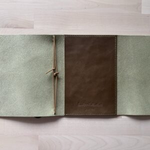 Trifold leather journal with a stitched pocket on the right