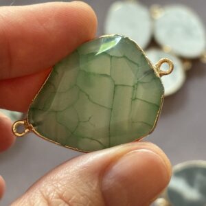 ‘Natural egg-shaped stone charm