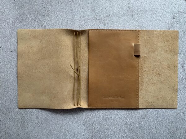 Trifold leather journal with a stitched pocket on the right