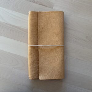 Trifold leather journal with two pockets inside